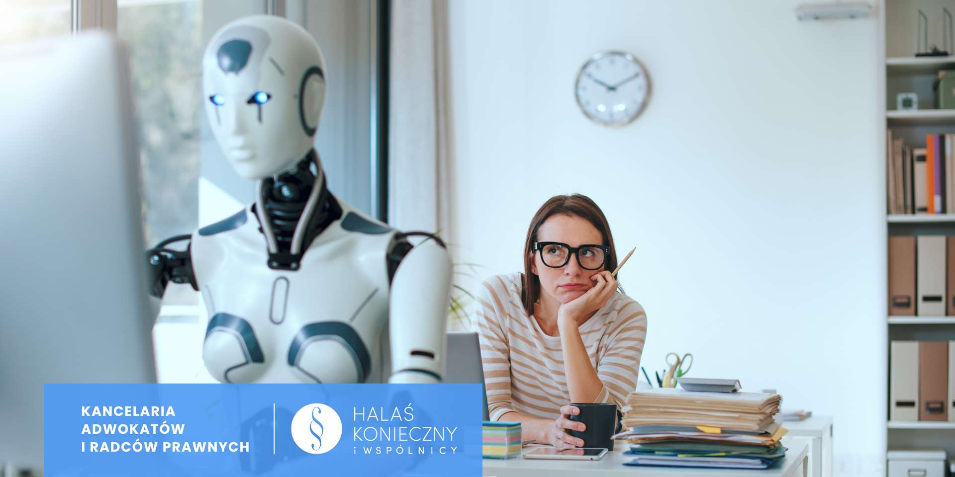 Office scene: a white humanoid robot sits beside a woman in glasses at a desk cluttered with papers and a mug, both focused elsewhere.